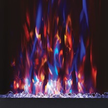 A close-up view of a decorative fireplace or flame effect with vivid blue, orange, red, and yellow flames rising above a bed of clear glass stones against a dark background.
