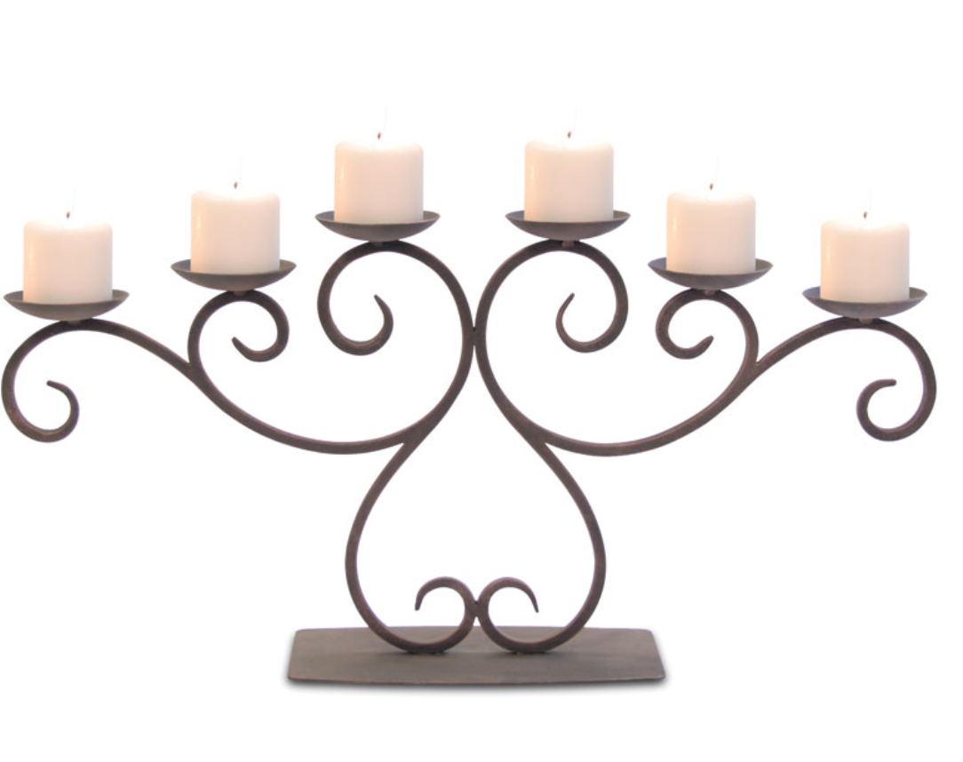 A dark metal seven-light candelabra with ornate scrollwork, shown holding seven white pillar candles on a plain white background.