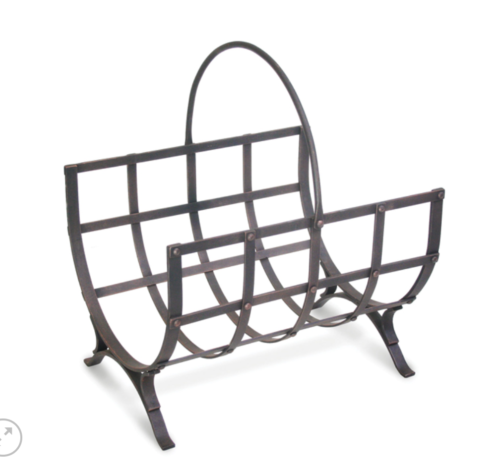 A dark metal firewood magazine rack with a curved top handle and grid-style bars, shown on a plain white background.