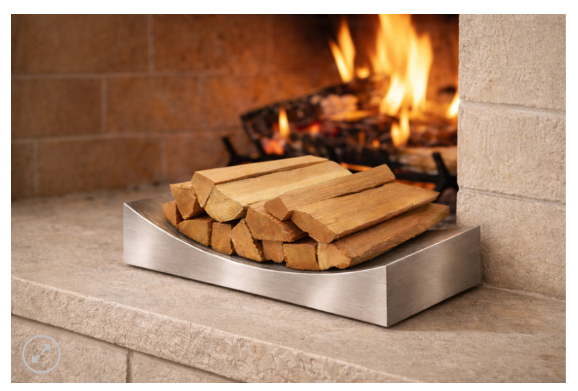 Brushed stainless steel wood holder in front of fire