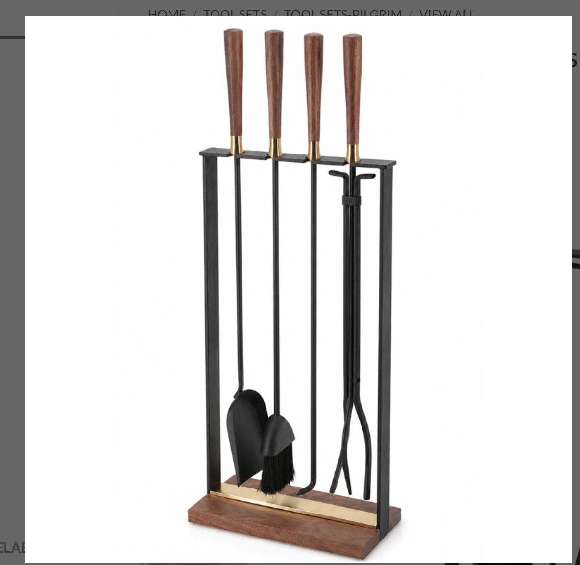 shows full set of the walnut handle fireplace tool set including four tools on a white background