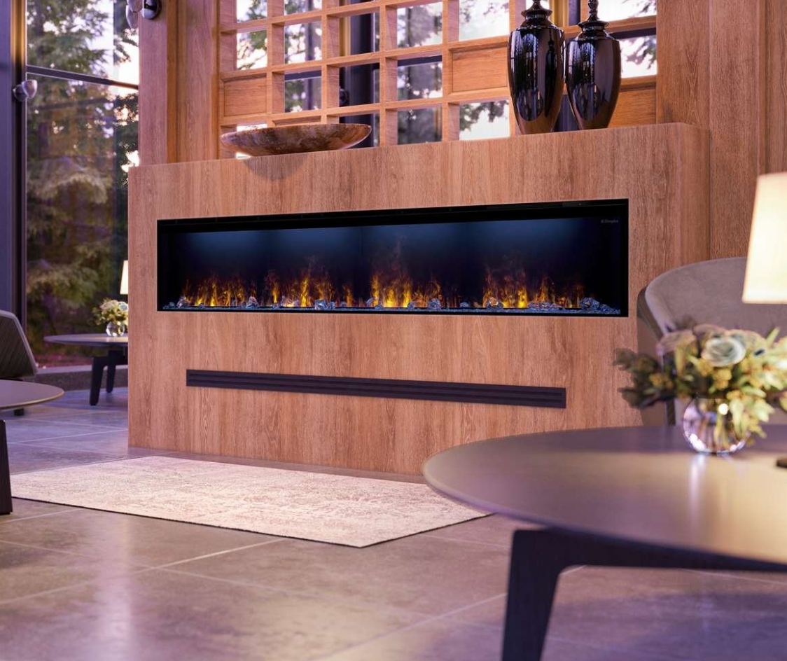 A modern linear electric fireplace with glowing yellow-orange flames, set into a light brown wood-paneled wall in a contemporary living room.