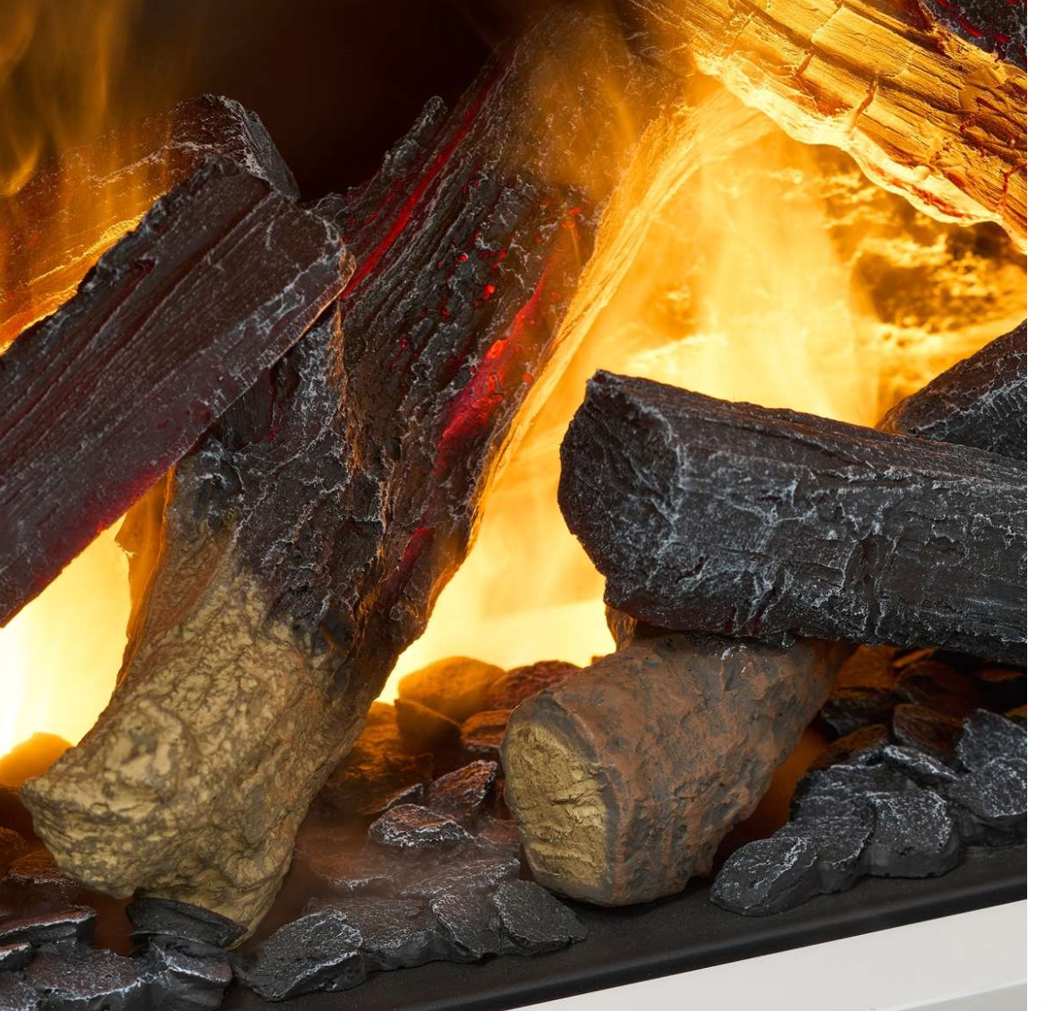 Close-up of a fireplace or stove with realistic faux logs, glowing orange and yellow flames, and dark embers.