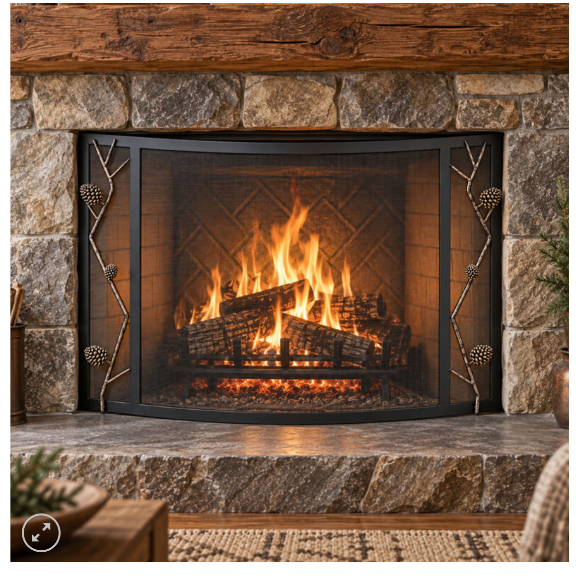 pine cone fireplace screen in front of a fire burning in a stone and wood firesplace