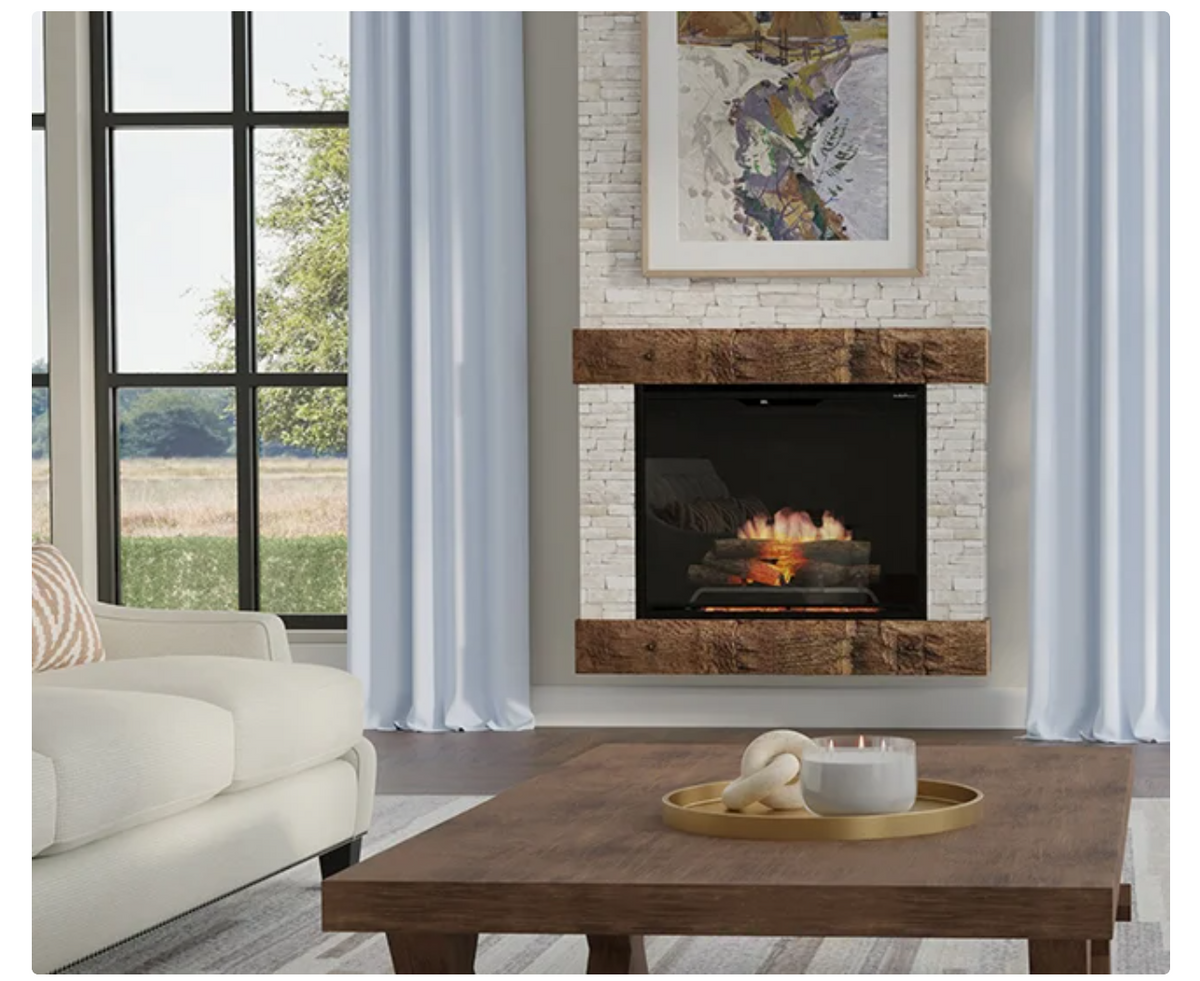 A modern fireplace insert with a white brick surround and dark wood mantel, shown in a styled living room setting with a wooden coffee table, white sofa, and light blue curtains.