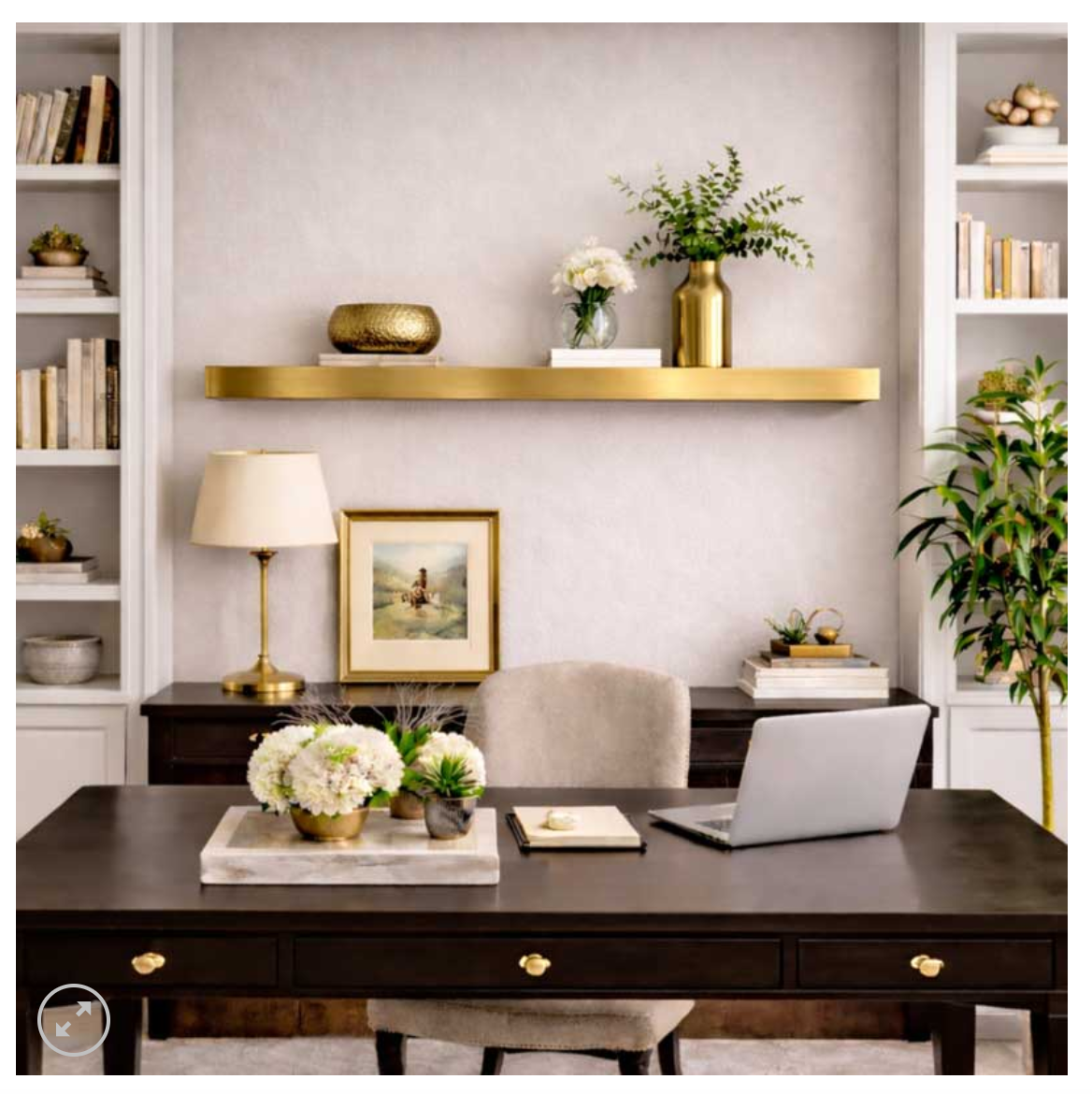 office with metal brass shelf on wall behind desk