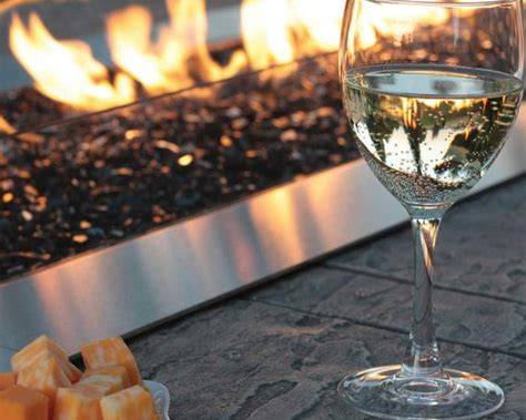 close up of gas flame with a wine glass beside it