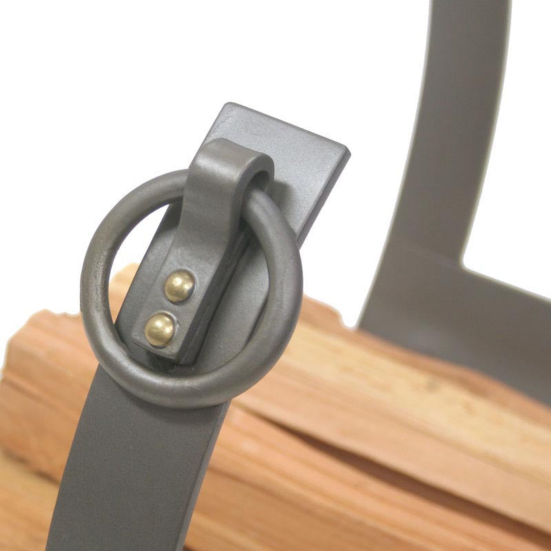 Close-up of a metal handle on a wooden surface with a white background