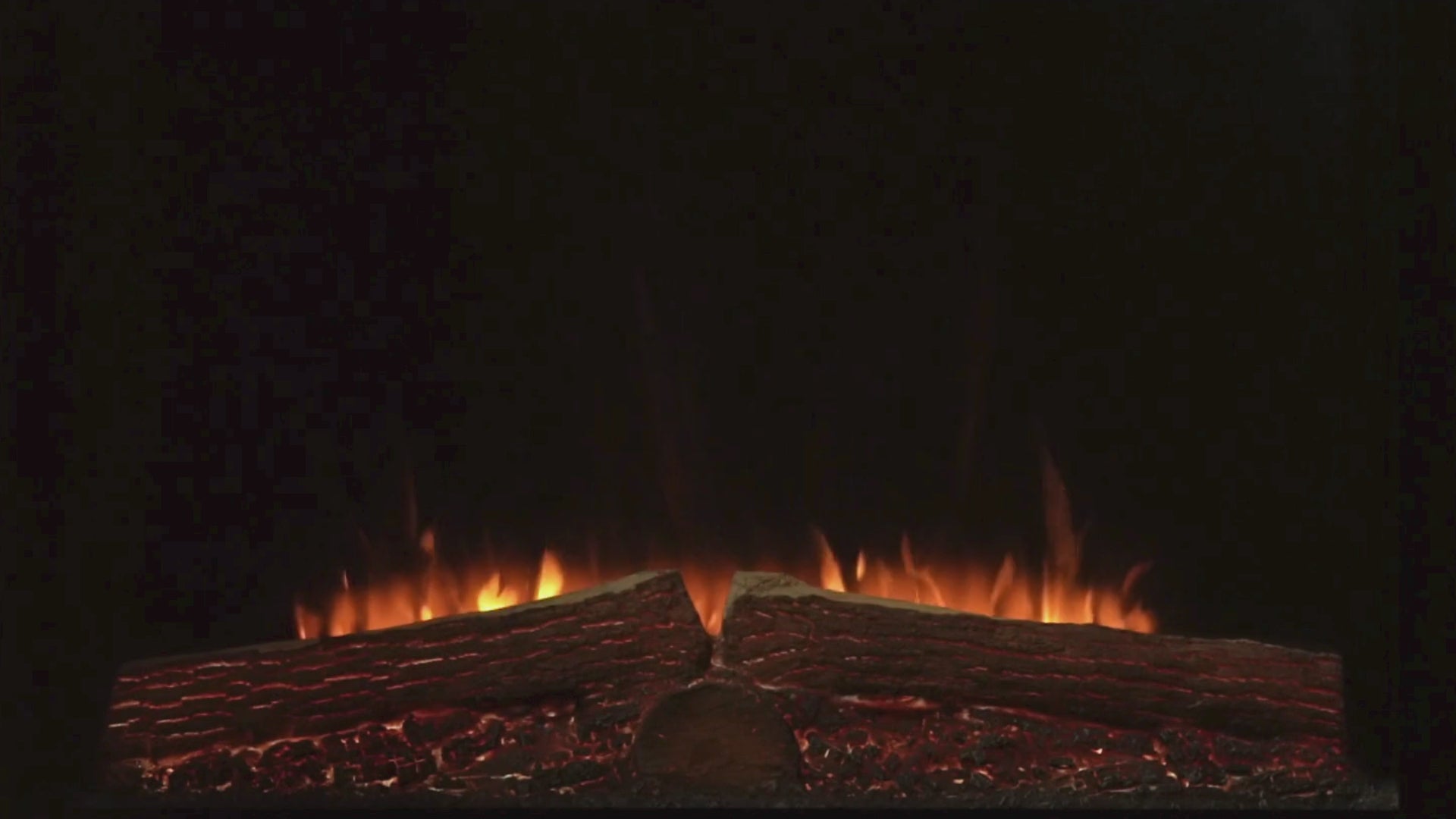 Moving flame image showing various color flames with two logs